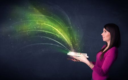 Casual young woman holding book with green wave flying out of it