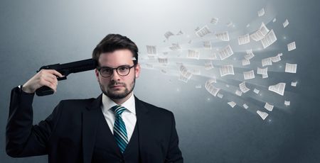 Handsome businessman shoots his head with gun and documents coming out from his head