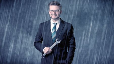 Young handsome  man holding tool with raindrop graphic