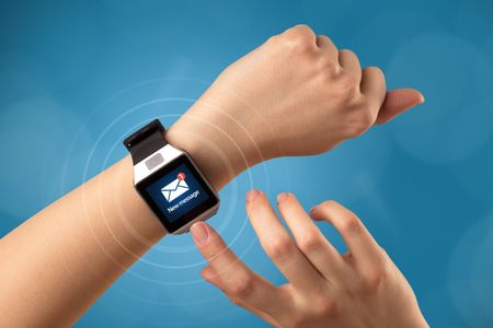 Female hand receives new message on her smartwatch
