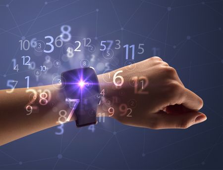 Close up female naked hand wearing smartwatch and numbers around