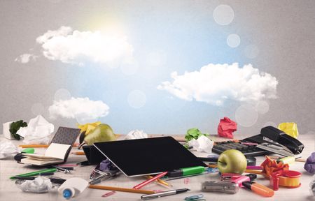 Close up of business office desk concept with clouds, blue sky and sunshine