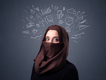 Young muslim woman wearing niqab with mixed white drawings above her head