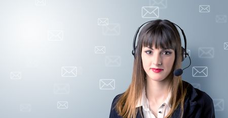 Young female telemarketer with white envelopes surrounding her