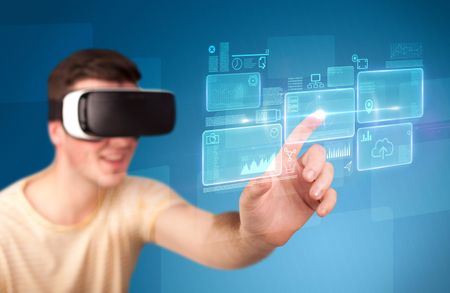 Young impressed man wearing virtual reality goggles with blue squares containing data at his fingers 