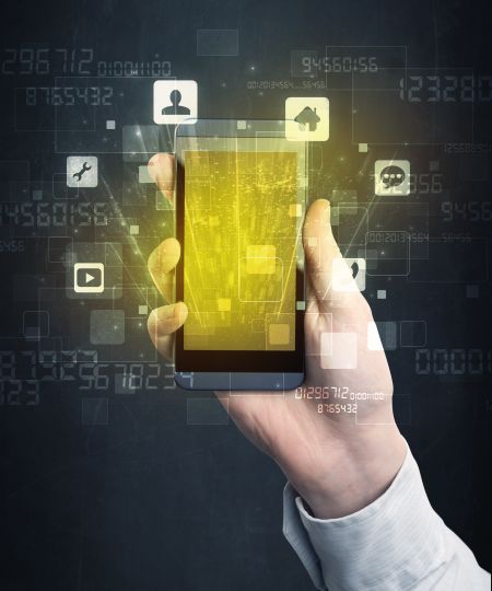 Caucasian hand in business suit holding a smartphone with golden-yellow holographic screen