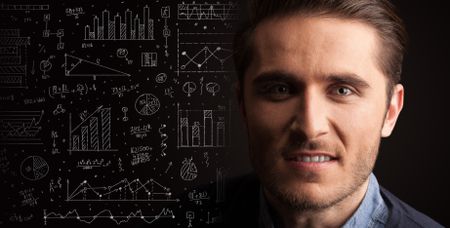 Portrait of a young businessman with charts and graphs scribbled next to him on a dark background