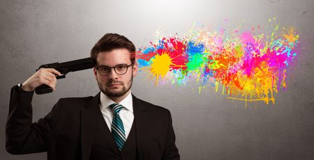 Man shoots his head with gun and colorful splotch are coming out from his head