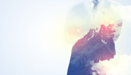 businessman-standing-thinking-snowy-mountain-graphic-678054172 Businessman standing and thinking with snowy mountain graphic