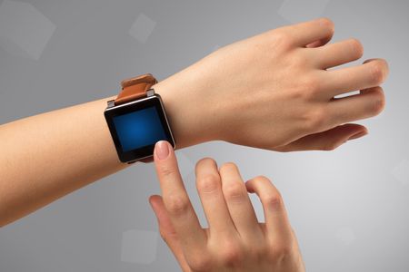Female hand wearing smartwatch with free space on the screen