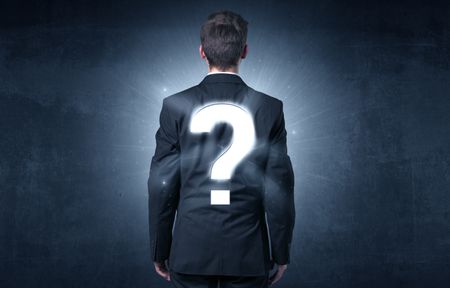 Businessman standing and thinking about questions