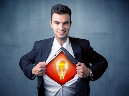 Businessman ripping off shirt and idea light bulb appears on his chest concept on backround