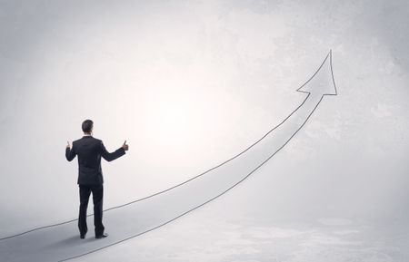 Adult elegant male with briefcase standing on drawn grey arrow pointing up financial concept