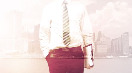 Businessman standing at cityscape background with warm light