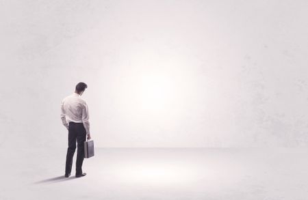 Elegant business person standing with his back looking at big empty white space concept