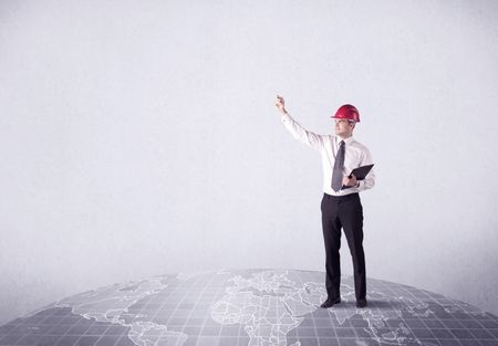 An elegant young male businessman standing on top of the world, pointing up concept with drawn earth map.