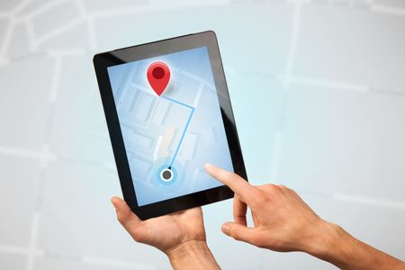 Female fingers touching tablet with map