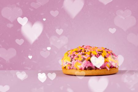 Delicious pretty party cakes with heart shape symbols on colorful background