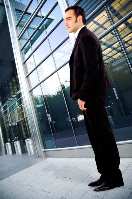 confident business man portrait outdoors in an office environment