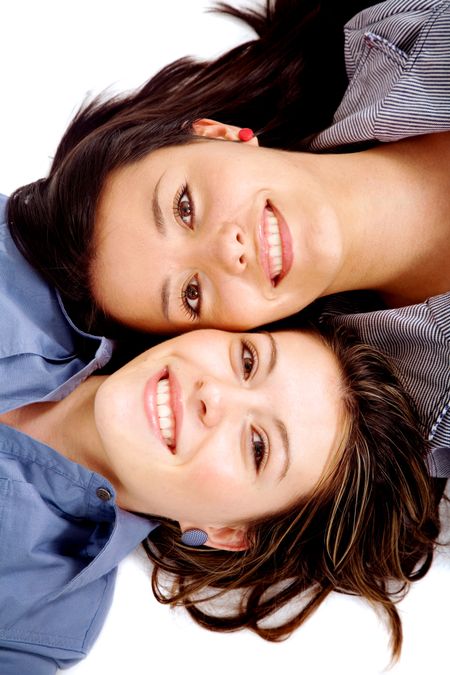 beautiful girls on the floor - sisters isolated over a white background