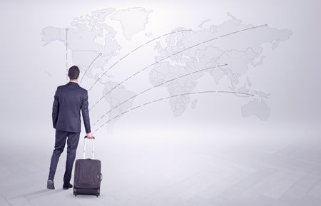 Businessman in dark suit planning his trip in a front of a map
