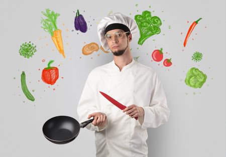 Bearded cook with colourful drawn vegetables on a white wallpaper