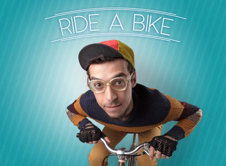 Kooky young guy on a bike with cyclist keywording and streaky background
