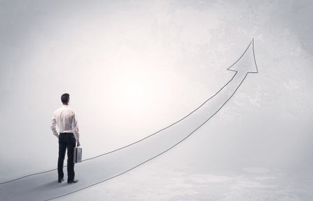 Adult elegant male with briefcase standing on drawn grey arrow pointing up financial concept