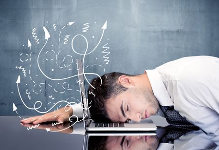 A depressed businessman resting his head on a keyboard and shouting with illustration of ideas, arrows, lines leaving his head concept