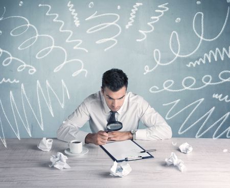 An elegant businessman sitting at office desk and working on keyboard with drawn curves, lines illustration on background wall concept