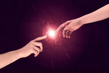 White caucasian male hands reaching out with fingers almost touching in bright red light sparkle in empty space background concept
