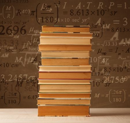 Books on vintage background with math formulas flying out