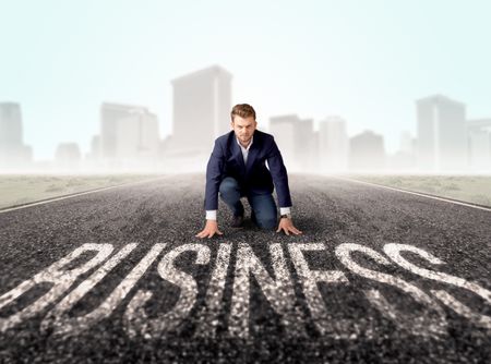 young-determined-businessman-kneeling-business-text-682515133 Young determined businessman kneeling before business text