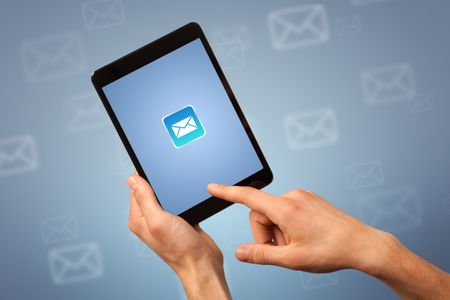 Female fingers touching tablet with mail icon on it 