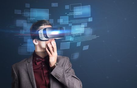 Amazed businessman with virtual reality data and blue squares in front of him