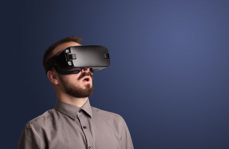 Amazed businessman with virtual reality goggles