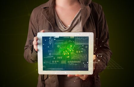 Casual young woman holding tablet with strategy and business related graphics