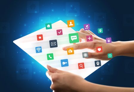 young-female-hand-holding-tablet-colorful-684118078 Young female hand holding a tablet with colorful mixed media icons