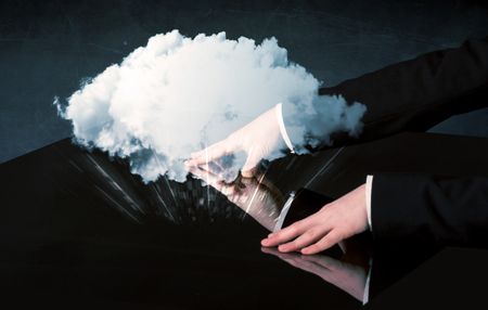 Male hands touching interactive table with a white cloud on it 