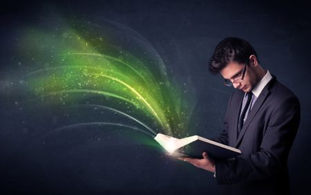 Casual young man holding book with green wave flying out of it