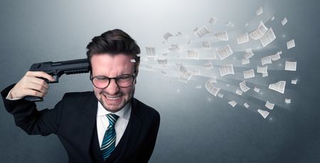 Handsome businessman shoots his head with gun and documents coming out from his head