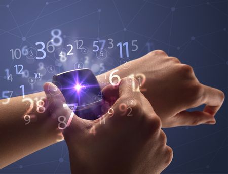 Close up female naked hand wearing smartwatch and numbers around