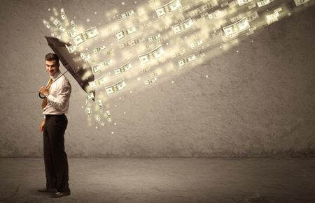 Business man holding umbrella against dollar rain concept on grungy background