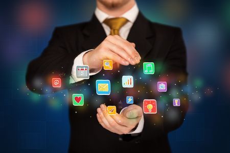 Elegant businessman holding colorful mixed media icons 