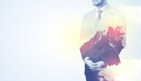 Businessman standing and thinking with snowy mountain graphic