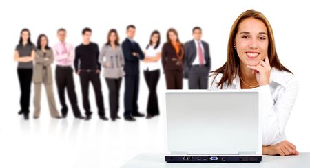 business team in the background with a businesswoman in an office laptop computer at the front - isolated over a white background