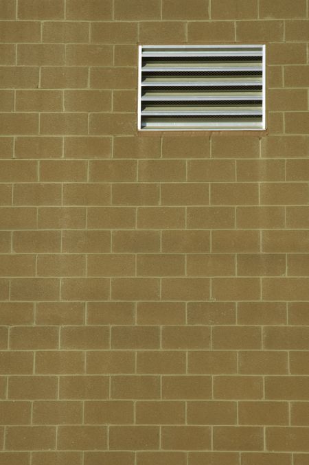 Rectangular vent in brick wall