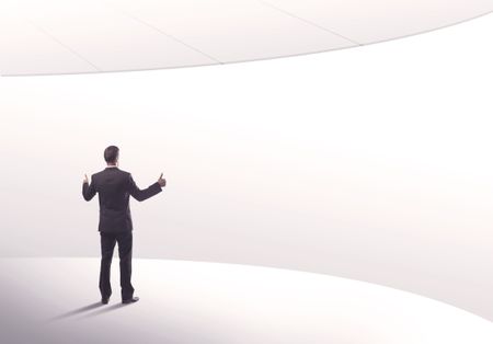 Young sales business person in elegant suit standing with his back in empty white space background with curved lines concept