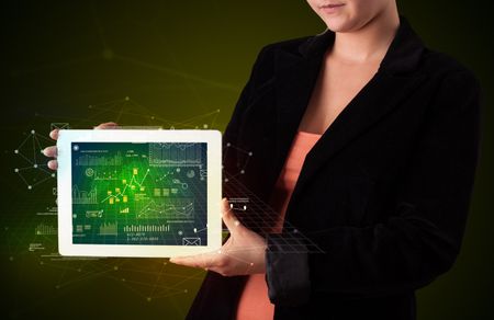 Casual young woman holding tablet with strategy and business related graphics