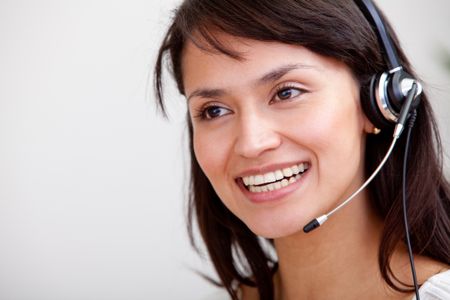 Female customer support operator with headset smiling